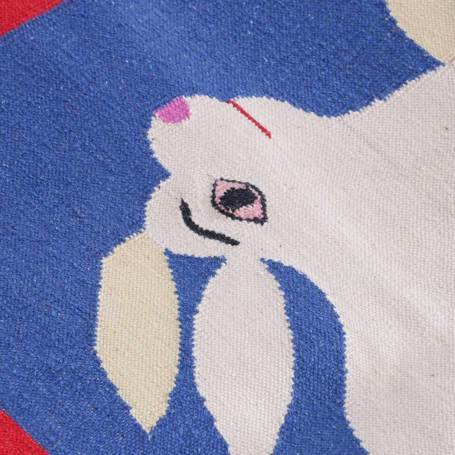 Close-up of a handwoven cotton rug highlighting camel and rabbit motifs and traditional Bikaner weaving craftsmanship