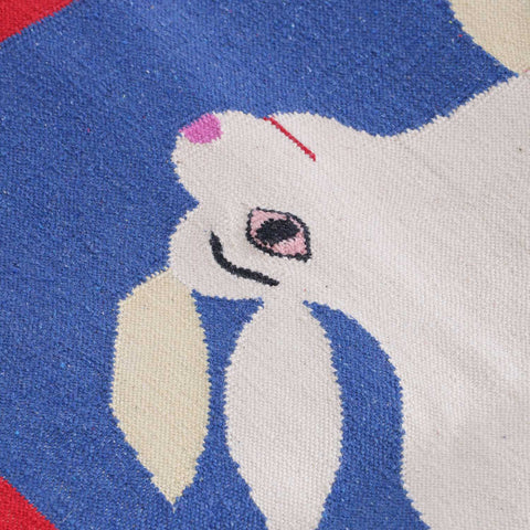 Close-up of a handwoven cotton rug highlighting camel and rabbit motifs and traditional Bikaner weaving craftsmanship