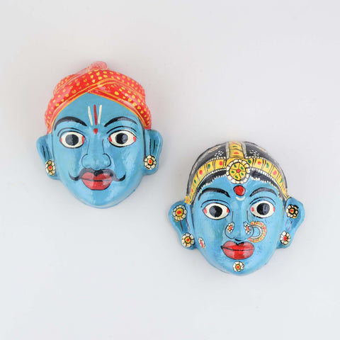 Hand-painted blue Cheriyal couple mask set crafted from papier-mache, showcasing traditional Telangana folk art and intricate decorative details on a plain background