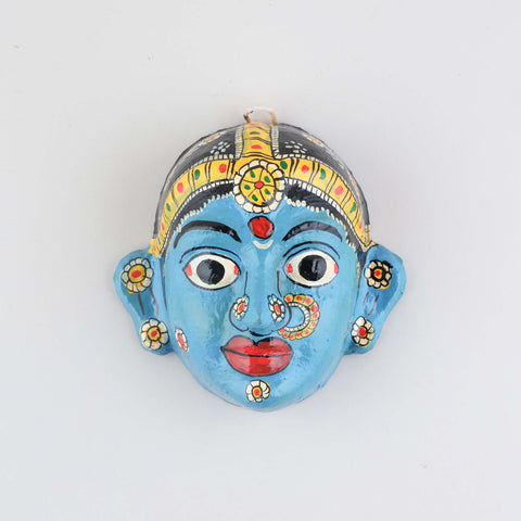 Hand-painted blue Cheriyal female mask crafted from papier-mache, featuring intricate folk art detailing and traditional craftsmanship on a plain background