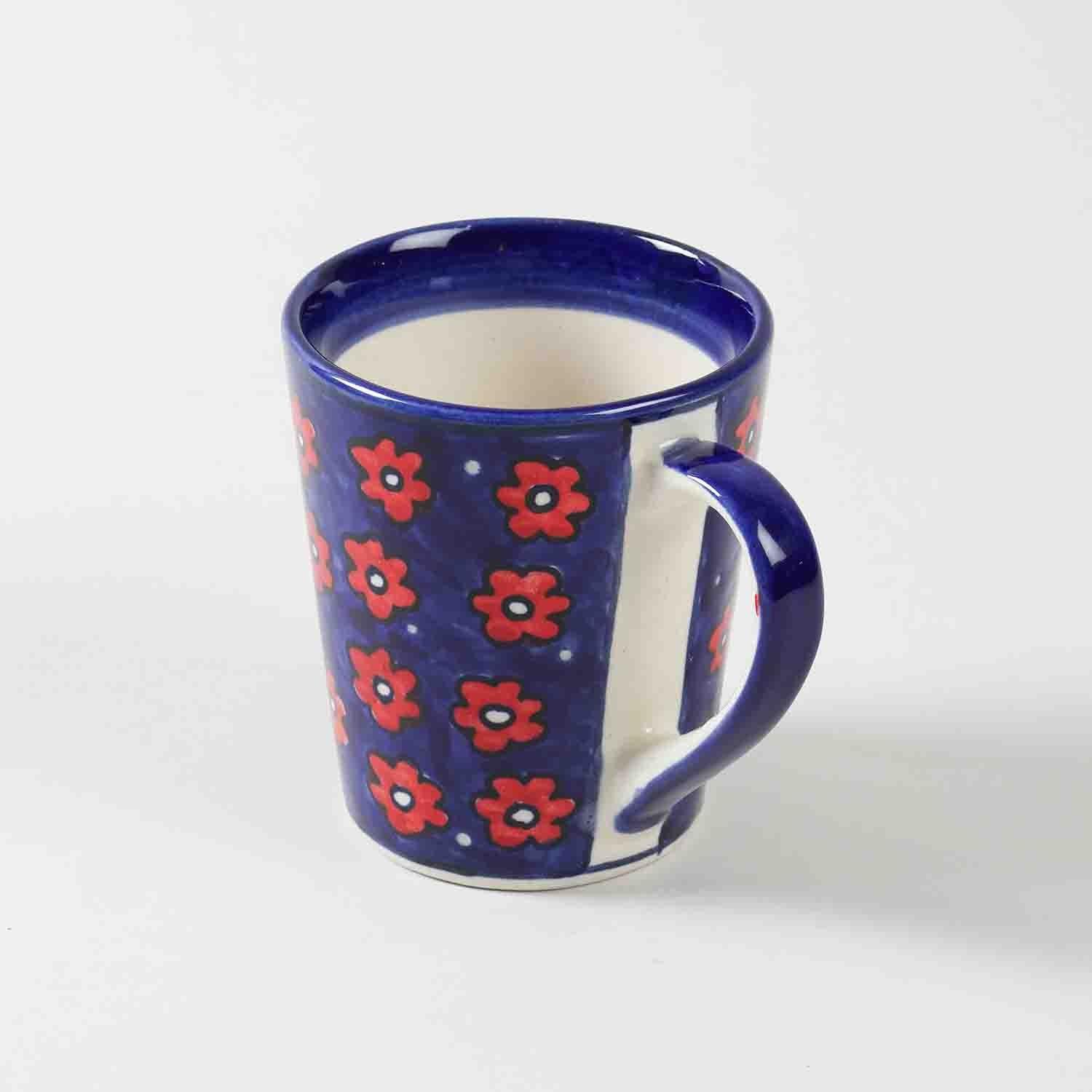 Front view of single blue floral hand-painted ceramic coffee mugs showcasing shape and decorative artwork