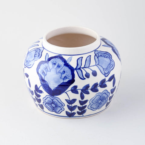 Blue floral ceramic storage jar shown with lid removed highlighting interior storage space and handcrafted finish