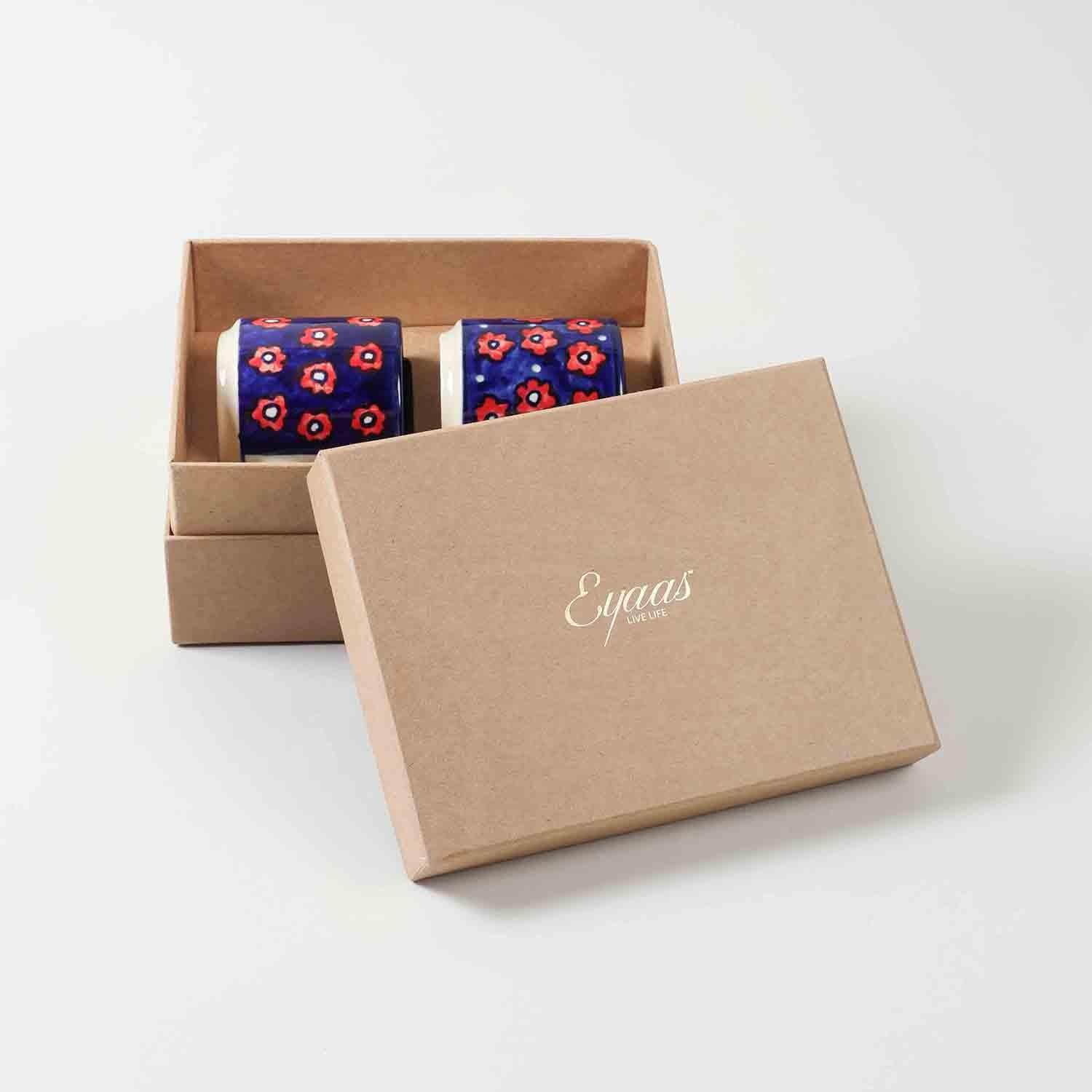 Open gift box displaying two blue floral hand-painted ceramic mugs ready for gifting on special occasions
