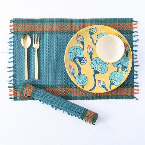 Flat lay and rolled view of blue Madhurkathi dining table placemats, and dining accessories showcasing eco-friendly dining table decor