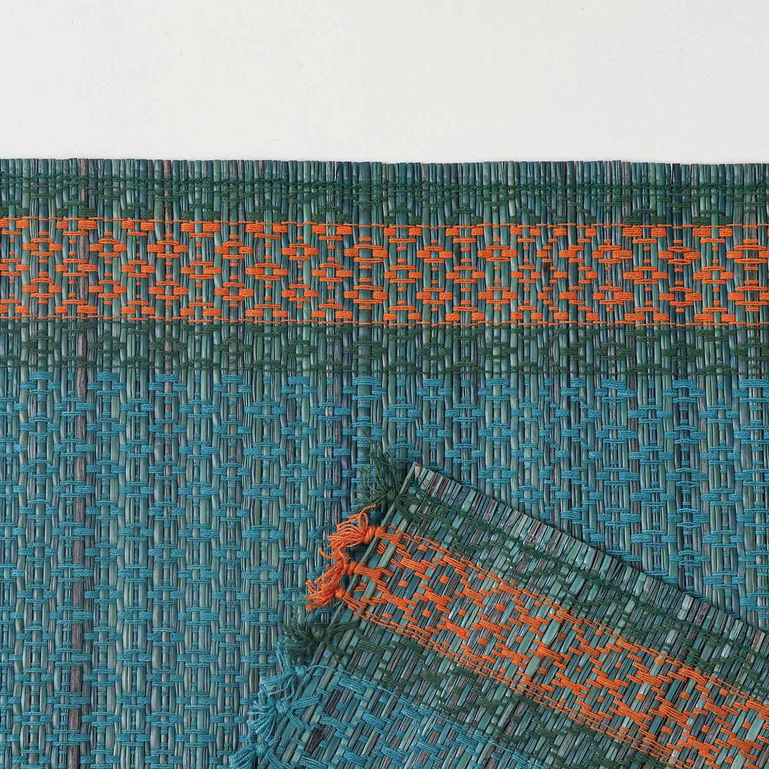  Detailed close-up of a blue Madhurkathi placemat showcasing the dense natural fibre weave, geometric pattern, and durable stitched border