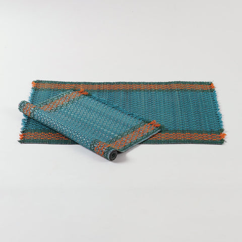Set of 2 blue Madurkathi placemats displayed as 1 flat and 1rolled showcasing handwoven river grass texture and colourful border accents