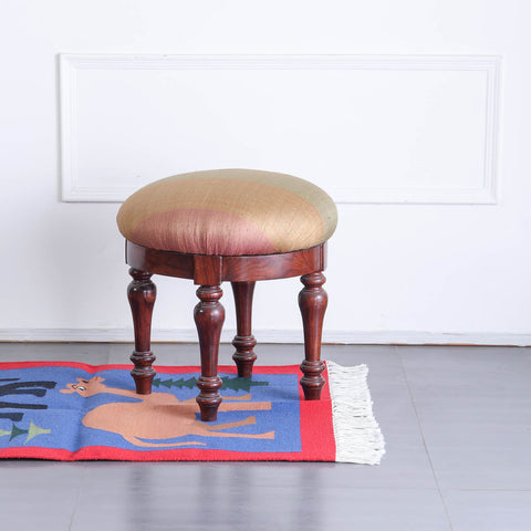 Handwoven cotton dhurrie with camel and elephant motifs styled in an entryway, adding colour and traditional charm