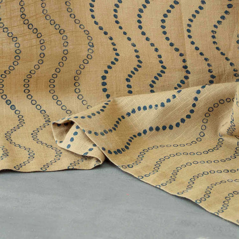 Close-up of the lower portion of Blue Wave hand block printed beige cotton curtains showing the handcrafted pattern and cotton slub texture.