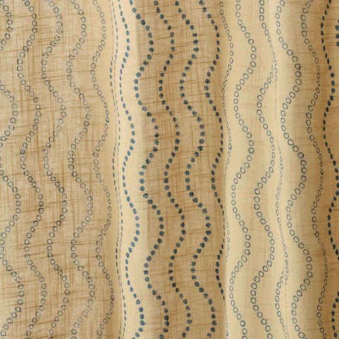 Close-up of beige cotton slub curtain fabric with a handcrafted Blue Wave block print.