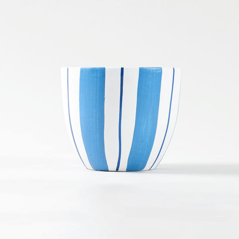 Blue and white striped ceramic flower pot shown at eye level with smooth curved U-shape structure.
