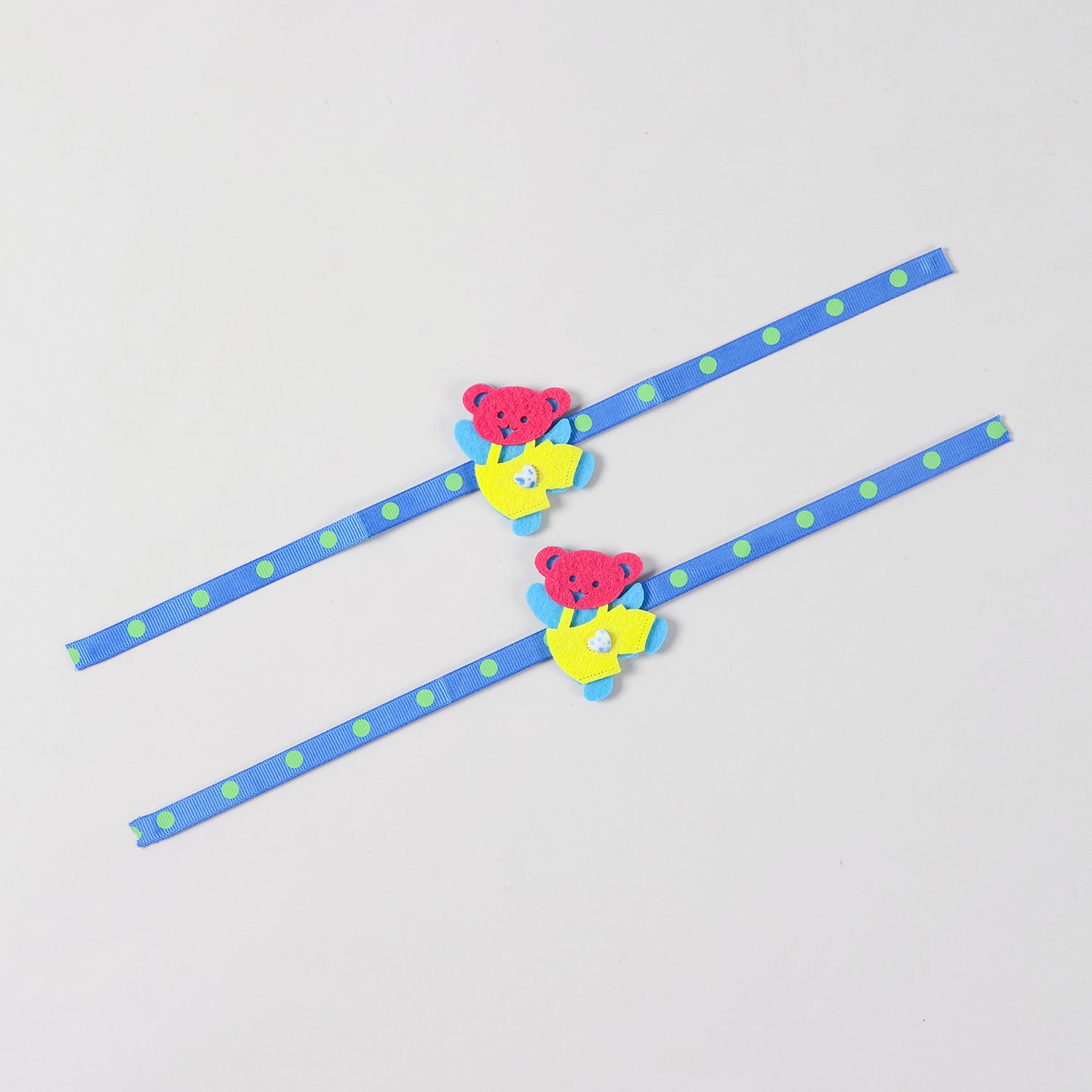 Full-length view of the blue and yellow Teddy Bear Felt Rakhi Kids Set of 2 showing the complete ribbon band and handcrafted teddy bear design.