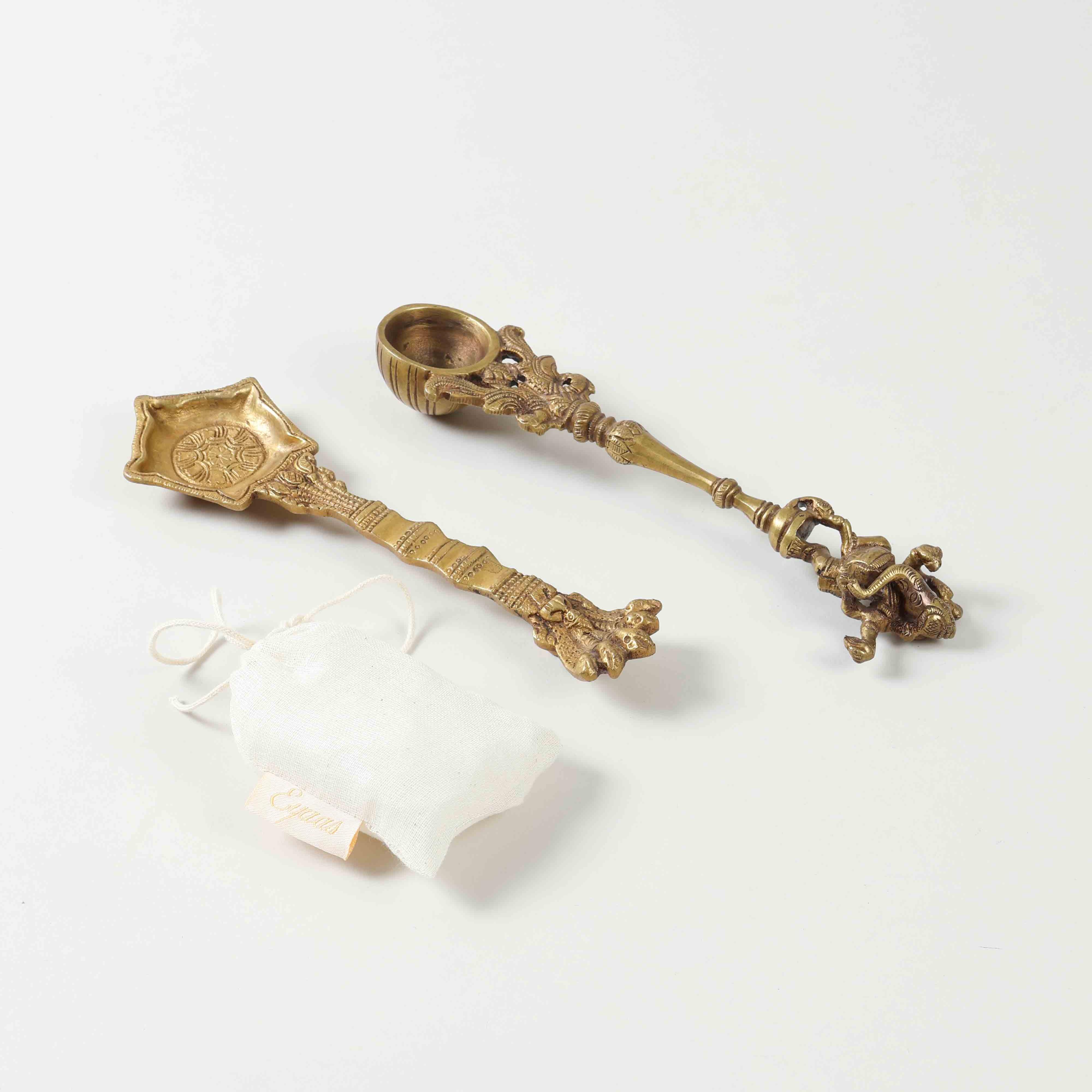 Angled view of a pooja ritual gift set containing brass hawan spoons and Kapoor for festive gifting