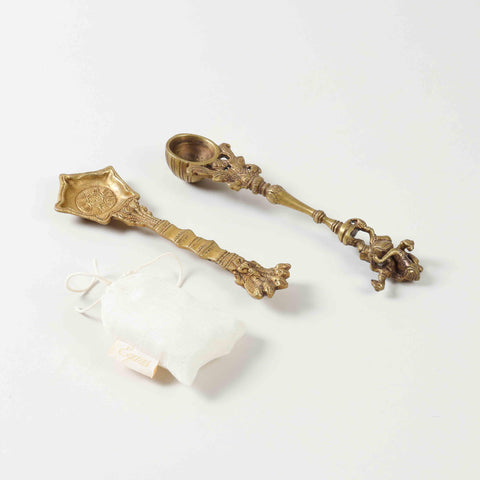 Angled view of a pooja ritual gift set containing brass hawan spoons and Kapoor for festive gifting