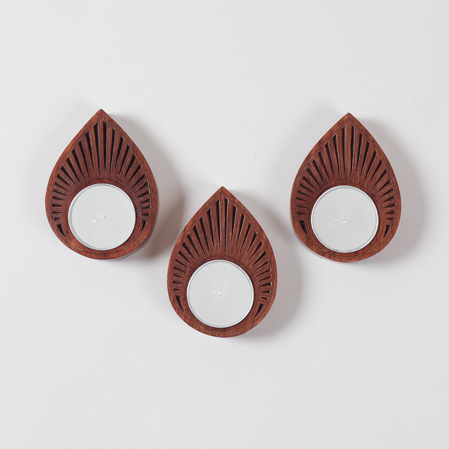Top view of a wooden T-light holder set of 3 showcasing raindrop shapes, brass inlay patterns, and handcrafted detailing