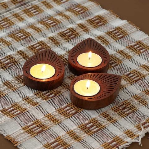 Brass inlay raindrop wooden T-light holder set of 3 displayed with lit tea lights, showcasing handcrafted wooden decor and elegant candle holder design