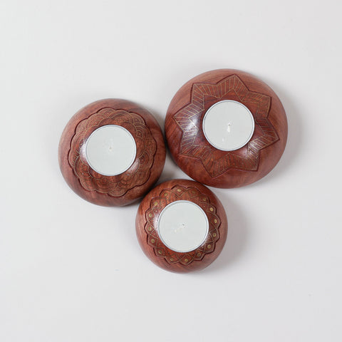  Hand carved wooden T-light holder set of 3 with brass inlay detailing, featuring star, scalloped, and lotus patterns on a plain background