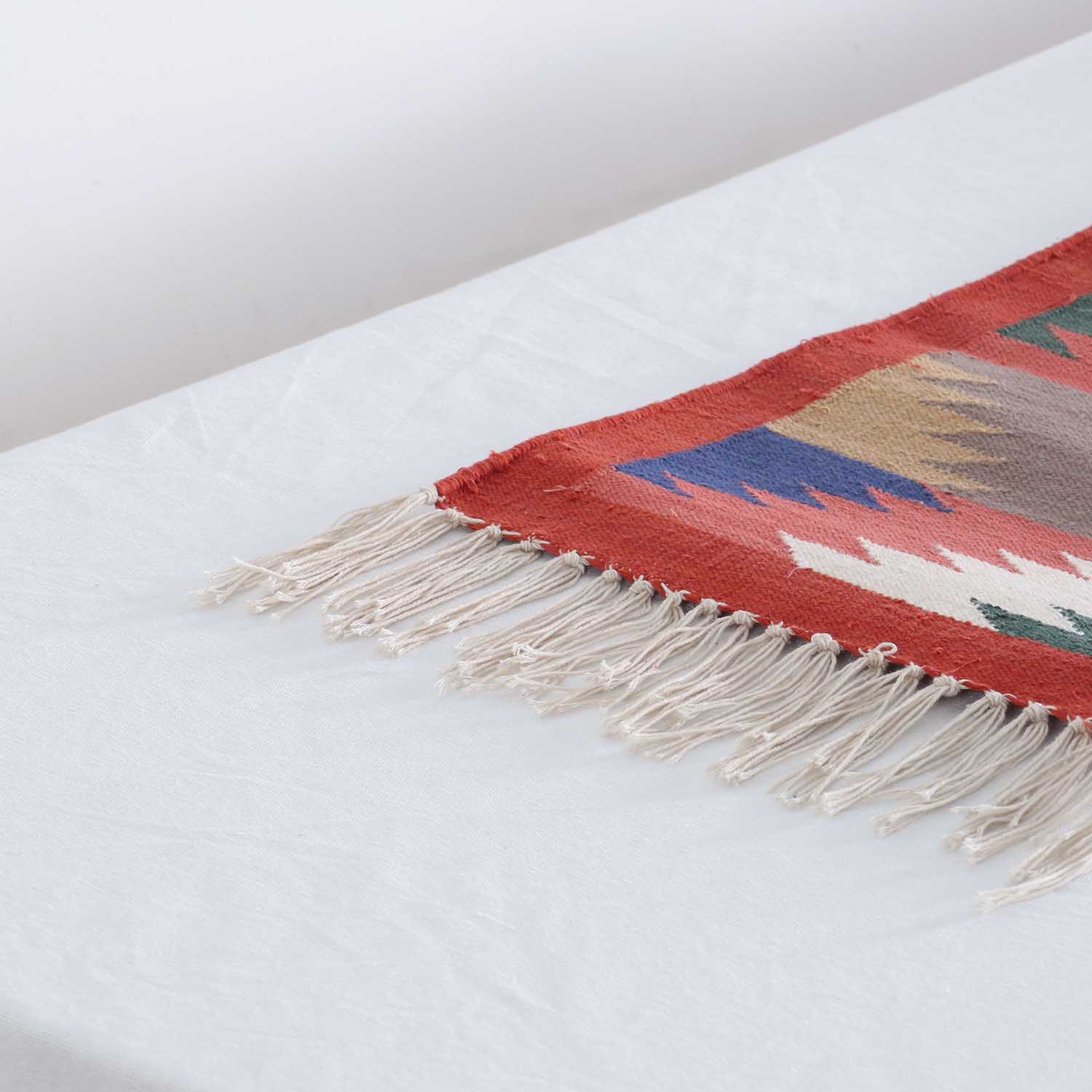 Close-up of geometric chevron patterns and textured cotton weave on a handcrafted Bikaner dhurrie runner 