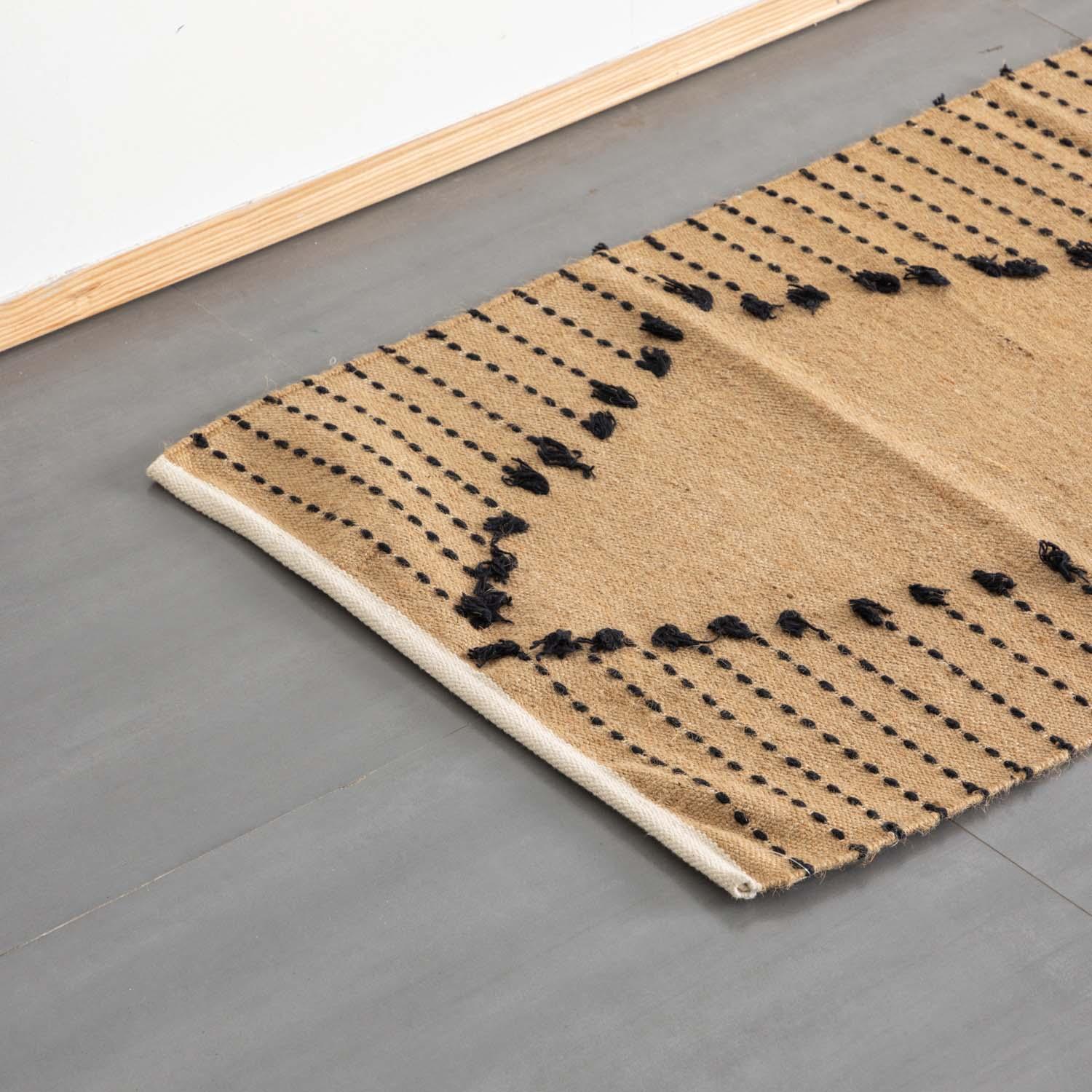Oblique high-angle view of a brown and black stripe handwoven cotton rug showcasing pattern placement and artisanal craftsmanship