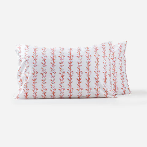Set of two handblockprinted cotton pillow covers with brown and red climbing vine block print design on a white background, handcrafted using traditional crafts