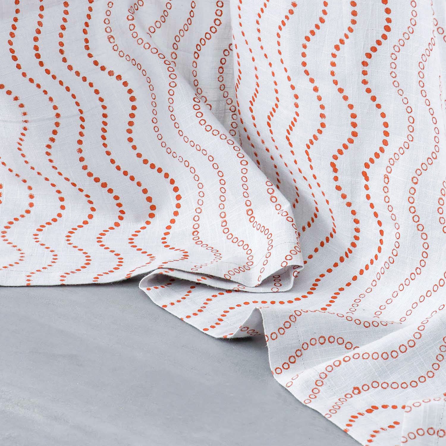 Close-up of the lower portion of Brown Wave hand block printed grey cotton curtains showing the handcrafted pattern and soft cotton slub fabric.
