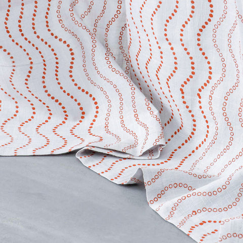 Close-up of the lower portion of Brown Wave hand block printed grey cotton curtains showing the handcrafted pattern and soft cotton slub fabric.