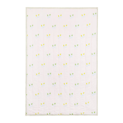  Back side of a reversible cotton quilt with coordinating  carrot block printed patterns in soft multicoloured tones