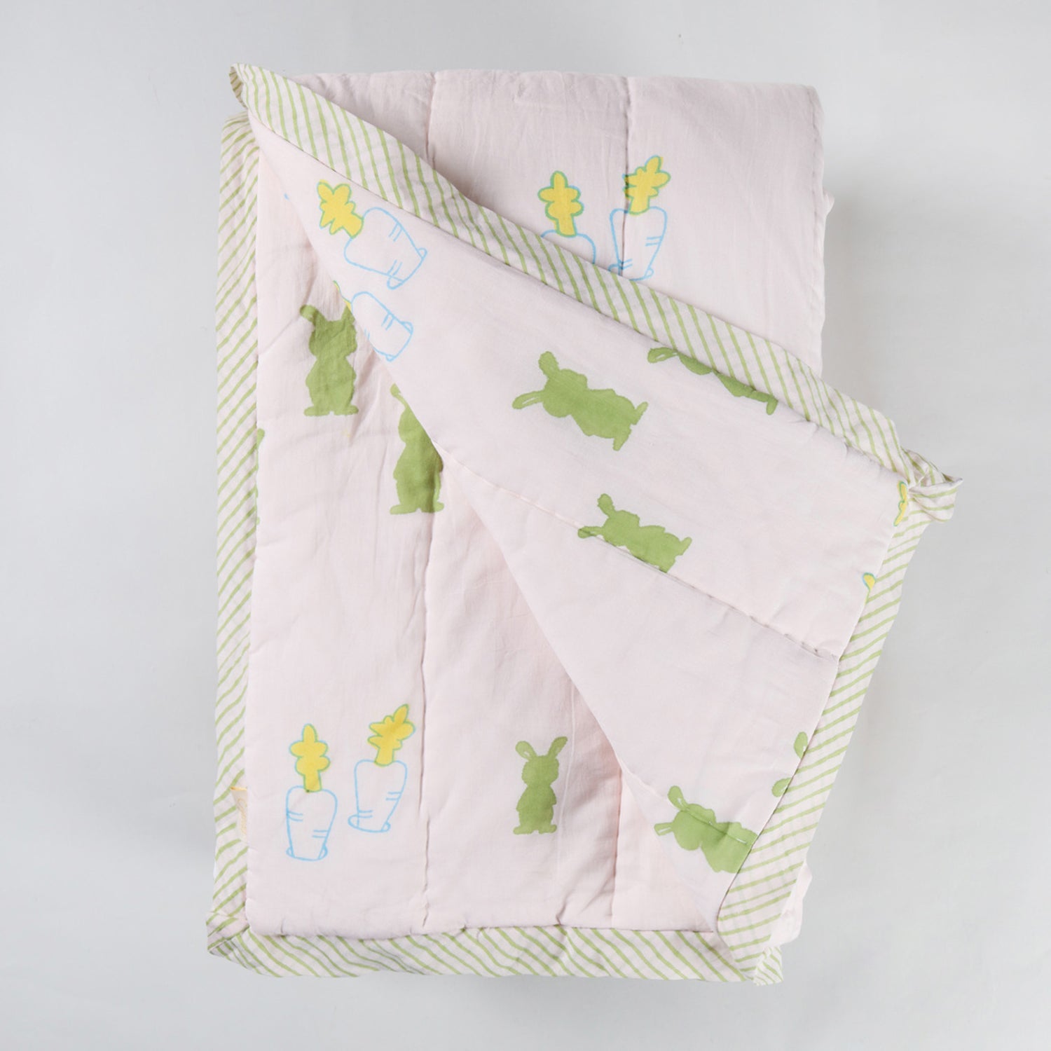  Reversible cotton quilt displaying both front and back designs with hand block printed bunny and carrot motifs on breathable cotton fabric