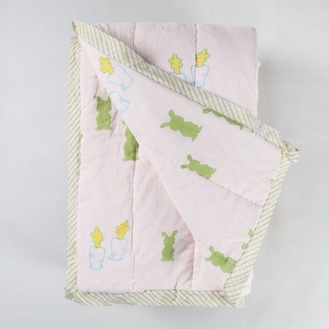  Reversible cotton quilt displaying both front and back designs with hand block printed bunny and carrot motifs on breathable cotton fabric