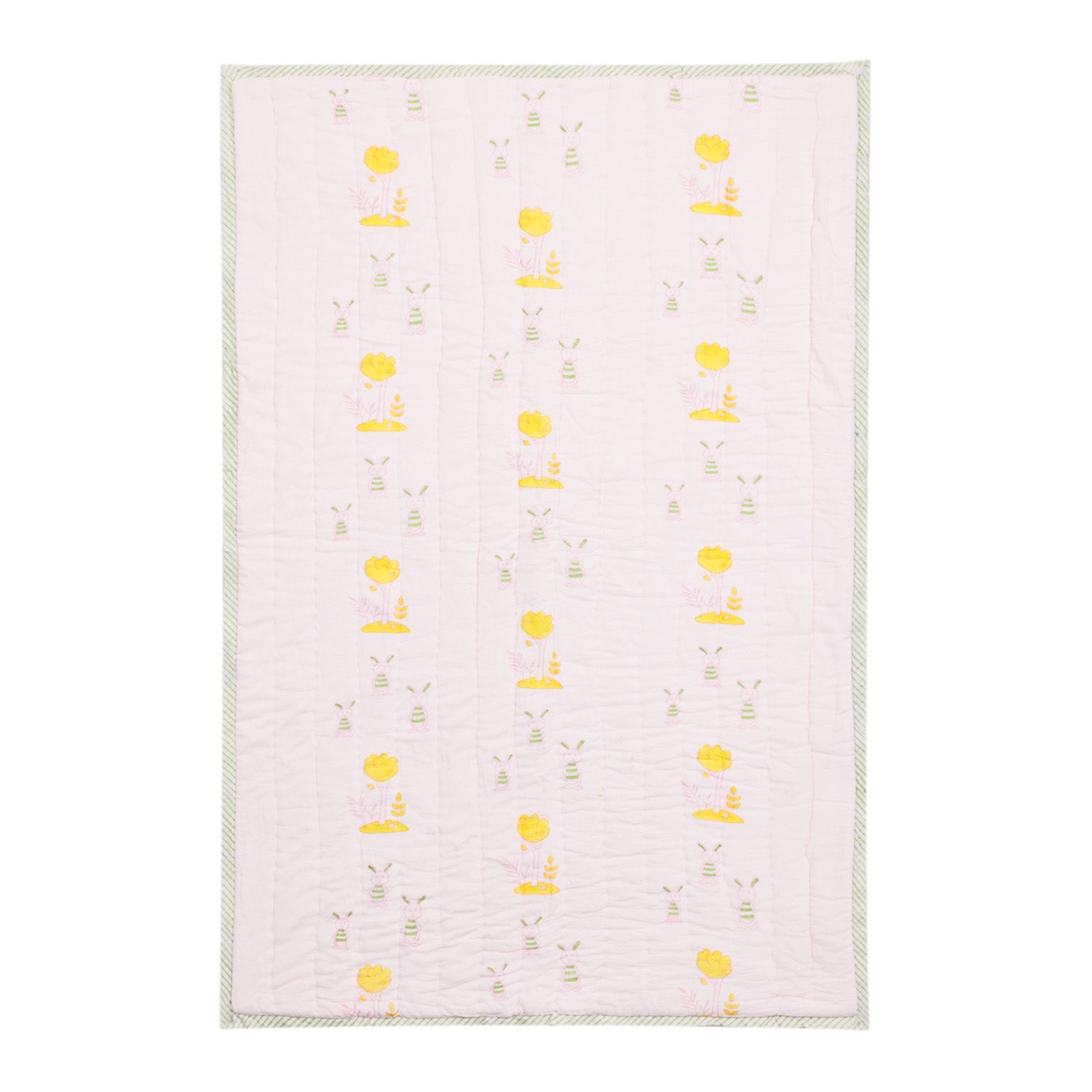 Full view of a 60x40 reversible cotton quilt featuring bunny and tree motifs in pastel shades on a light pink background