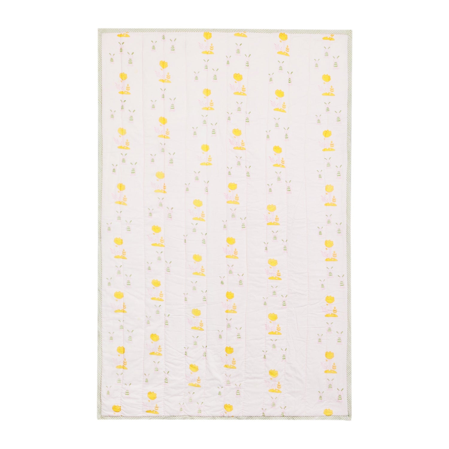 Single bed cotton quilt with repeating bunny and tree block print motifs on a light pink base, handcrafted for everyday comfort