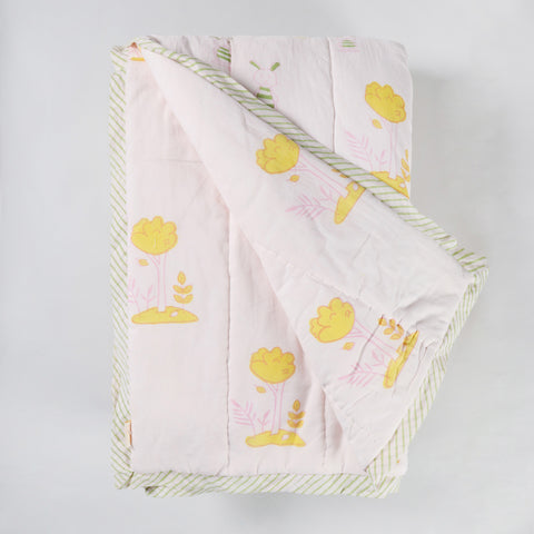 Reversible cotton quilt showcasing playful bunny and tree block printed patterns, suitable as a lightweight quilt and summer blanket