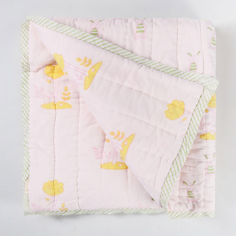 Reversible cotton quilt displaying both front and back designs with hand block printed bunny and tree motifs on soft breathable cotton