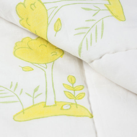 Close-up of bunny garden block printed cotton quilt fabric showing breathable cotton, stitching details, and soft multicolour prints