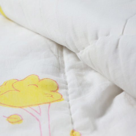 Close-up of bunny garden block printed cotton quilt fabric highlighting breathable cotton, stitching, and multicolour motifs