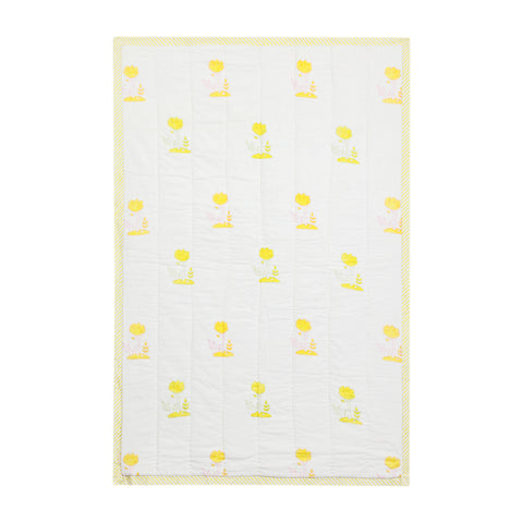 Front side of a 40x60 reversible cotton quilt with playful bunny and garden motifs on a white base with multicolour detailing