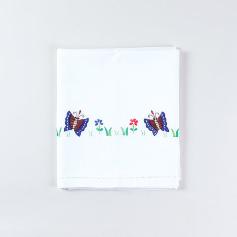 Folded cotton kids bedsheet and pillow cover set featuring colourful butterfly and flower hand embroidery on a white cotton base