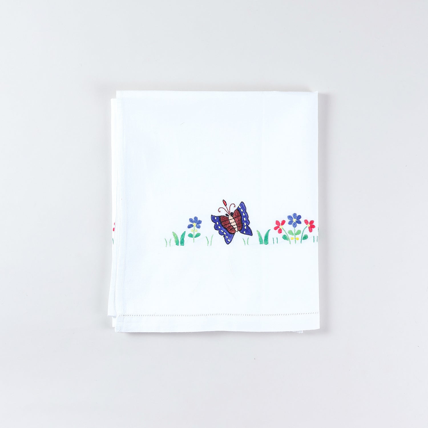 Embroidered kids bedsheet and pillow cover set featuring colourful butterfly and flower motifs with fine hand embroidery on white cotton