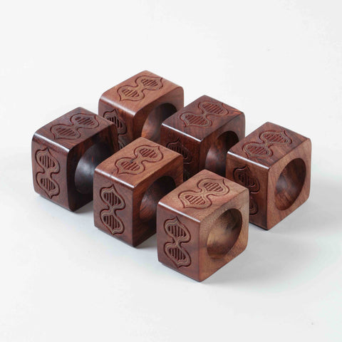 Set of six wooden napkin rings featuring butterfly inspired engraving and handcrafted brass inlay detailing