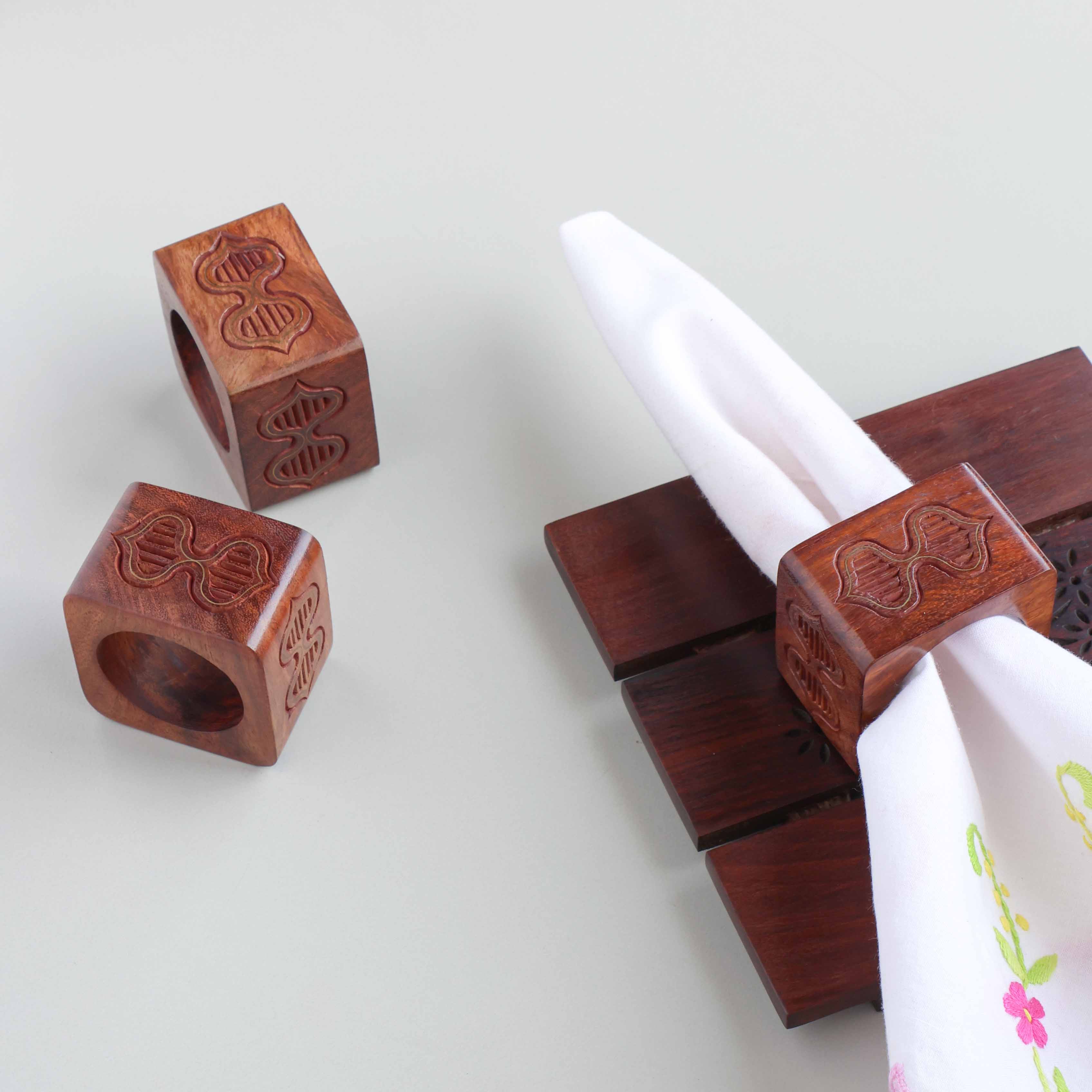 Butterfly motif wooden napkin rings with brass inlay styled on a dining table for elegant table setting decor