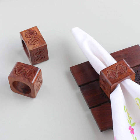 Butterfly motif wooden napkin rings with brass inlay styled on a dining table for elegant table setting decor