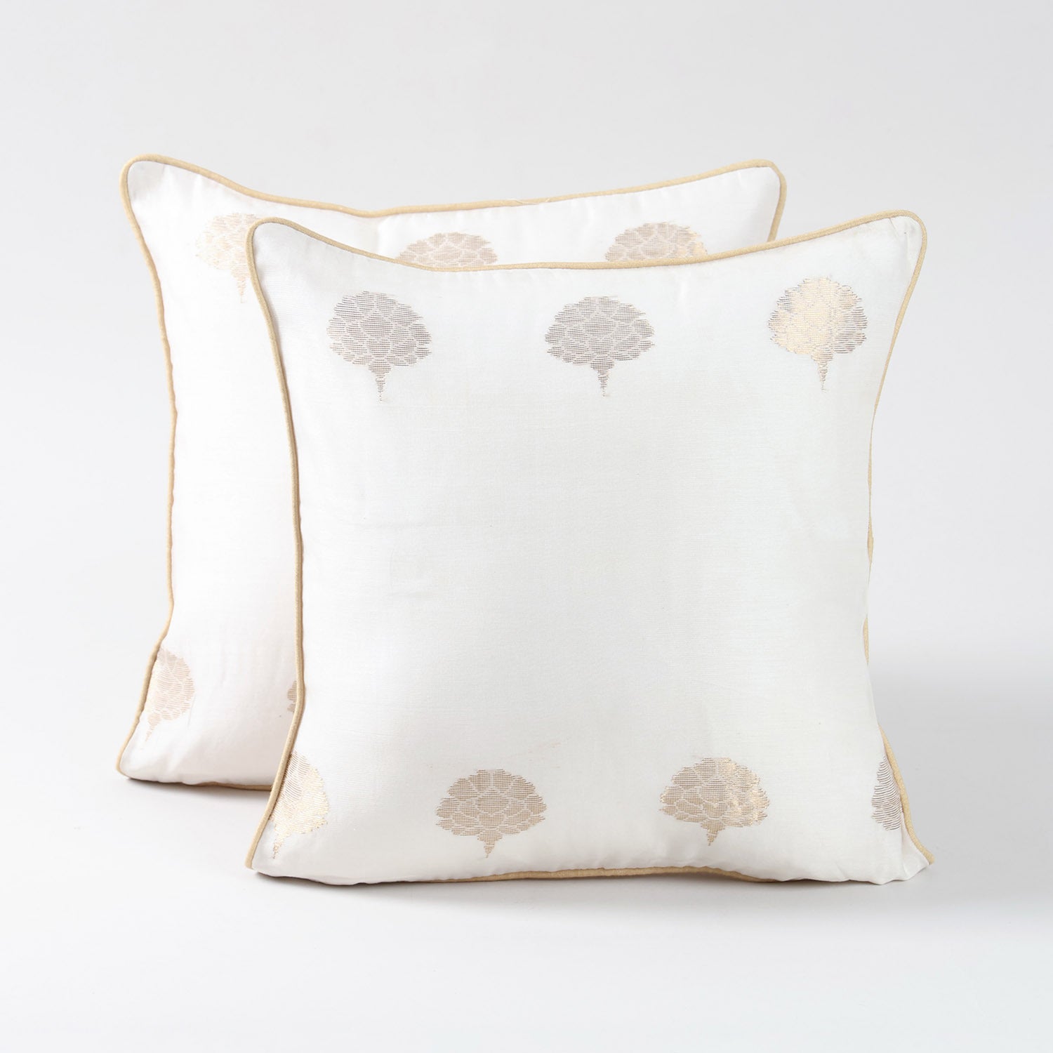 Set of two off-white Chanderi cushion covers featuring woven tree motifs and a soft lustrous finish