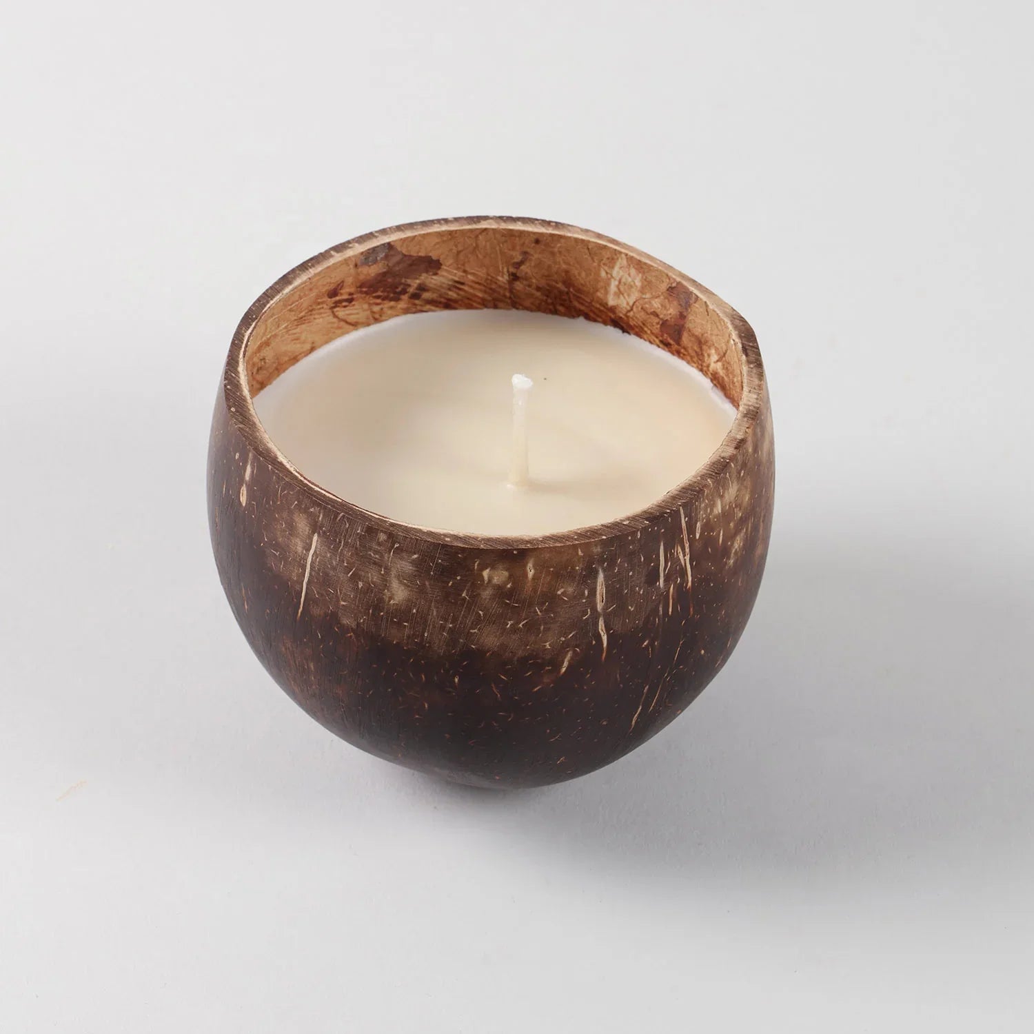 Front view of a handmade coconut shell soy wax candle with Choco Vanilla fragrance