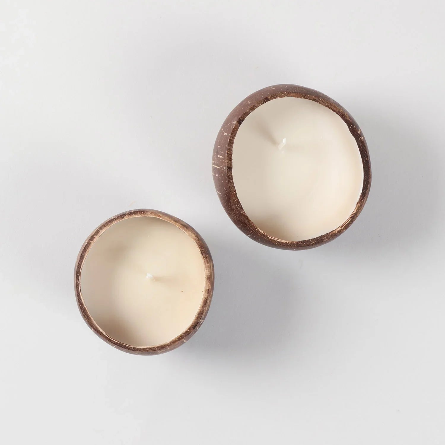 Top view of a natural coconut shell candles filled with scented soy wax
