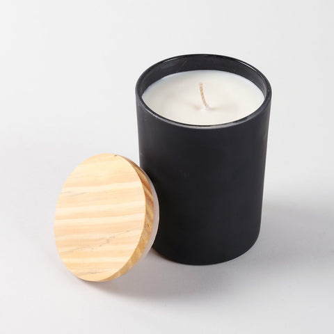 Top view of an open coffee scented soy wax candle showing smooth wax surface inside a glass jar