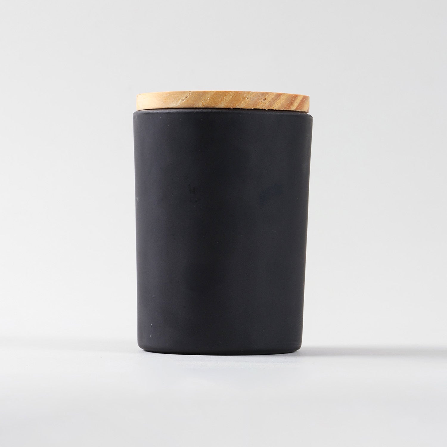 Coffee scented soy wax jar candle showcasing black glass container and wooden lid