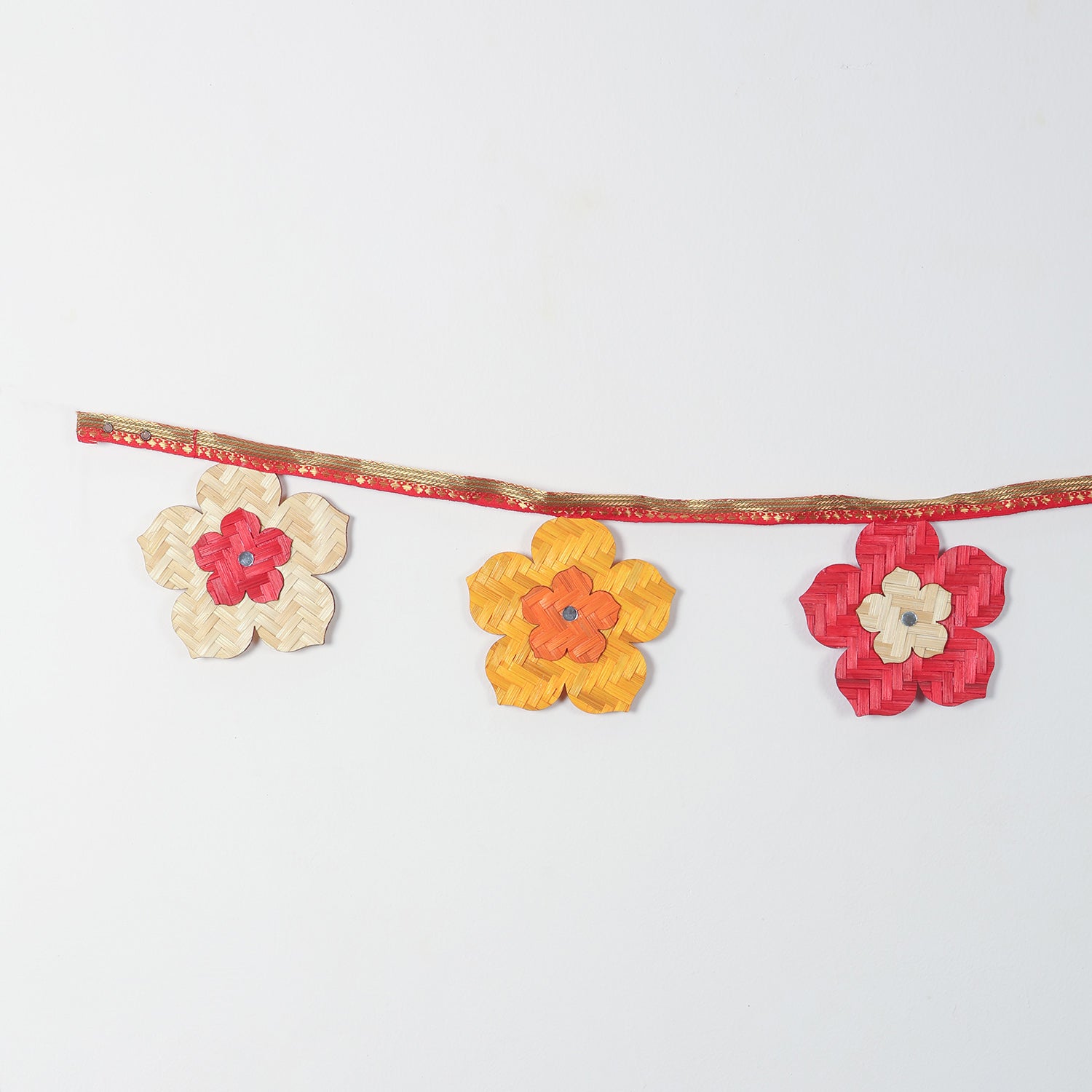 Handwoven bamboo flowers in festive colours like beige,  yellow, and red