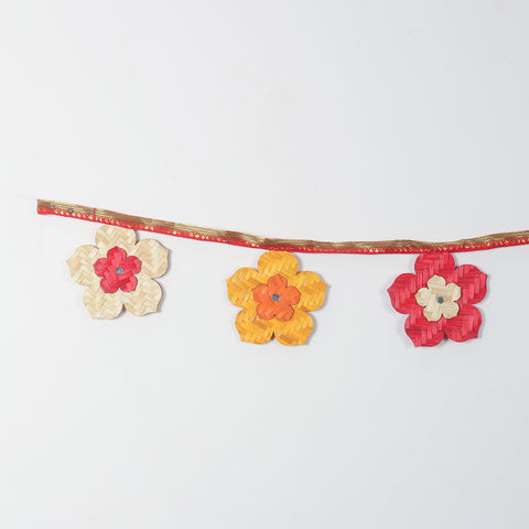Handwoven bamboo flowers in festive colours like beige,  yellow, and red