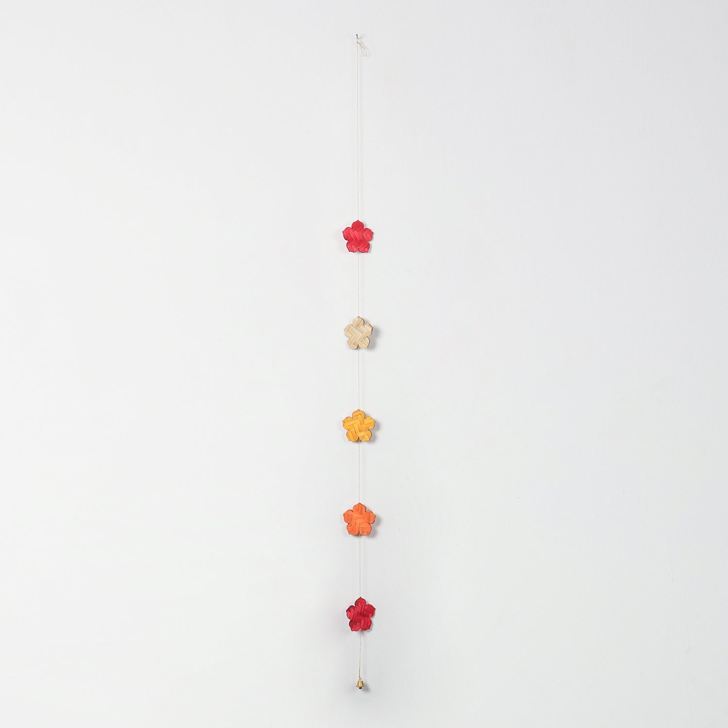 Red, yellow, orange, and natural beige flowers on a bamboo hanging