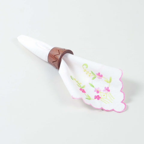 Handcrafted conical wooden napkin ring holding a folded table napkin for refined dining table decor