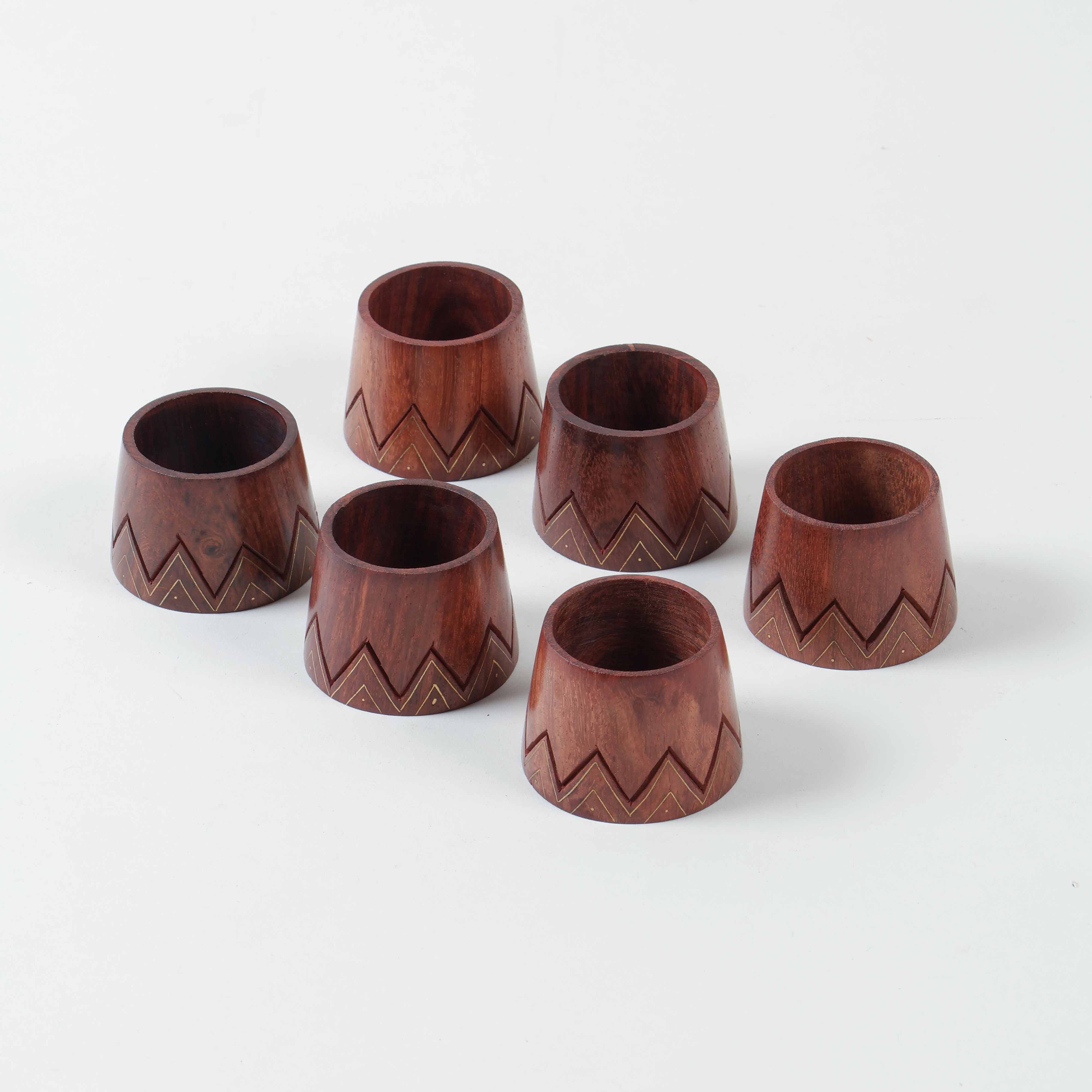 Set of six conical wooden napkin rings featuring handcrafted brass inlay and timeless dining table styling